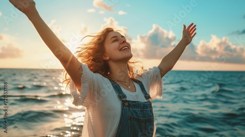 happy young woman enjoying freedom with open hands on sea