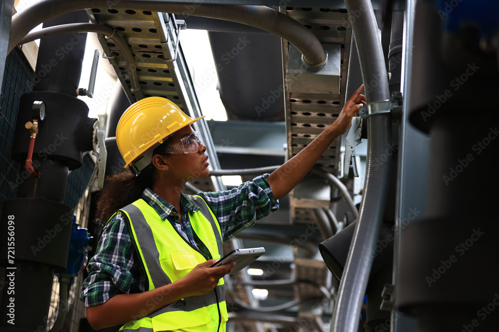 custom made wallpaper toronto digitalFemale engineer wearing a yellow safety vest and yellow helmet working check Industry cooling system, HVAC of large industrial building