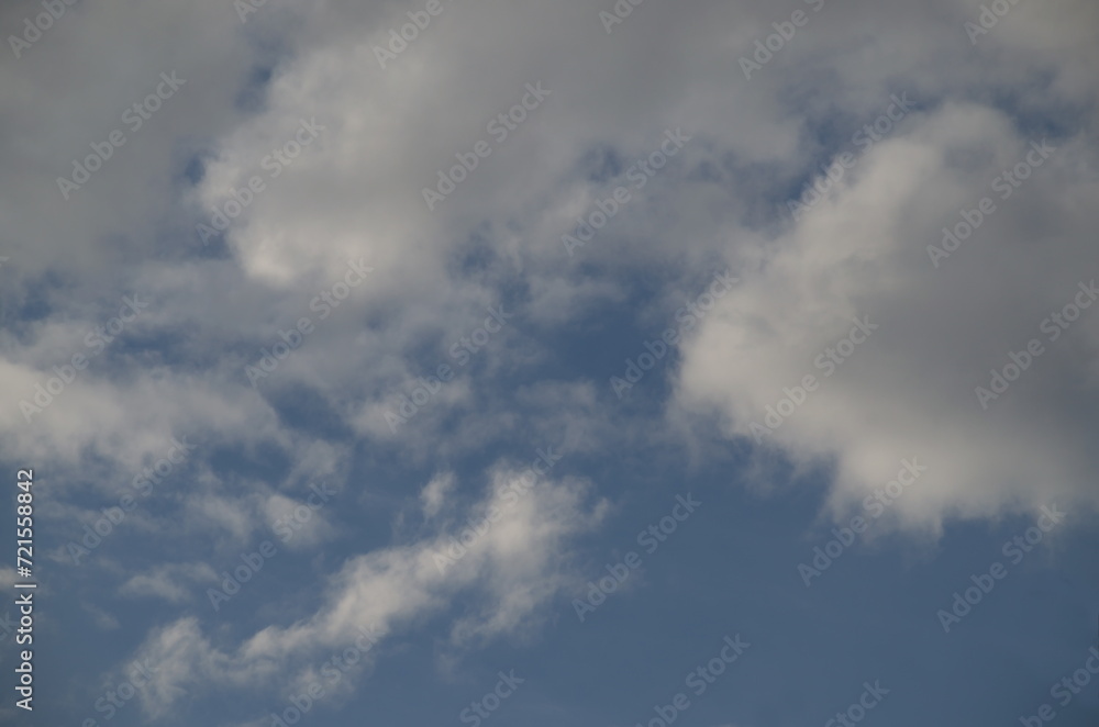 Background of rainy fluffy clouds floating on a bright blue sky, Sofia, Bulgaria  