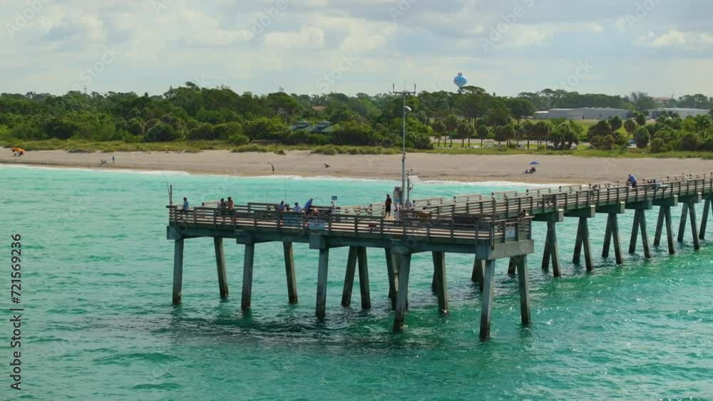 Aerial view of many tourists enjoying vacation time on Venice fishing pier. Seaside summer activities Aerial view of many tourists enjoying vacation time on Venice fishing pier. Seaside summer activities