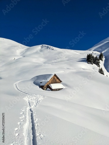 Snowy alp in the Glarus mountains. Beautiful mountain landscape. Hut discovered on a ski tour. High quality photo. Skimo