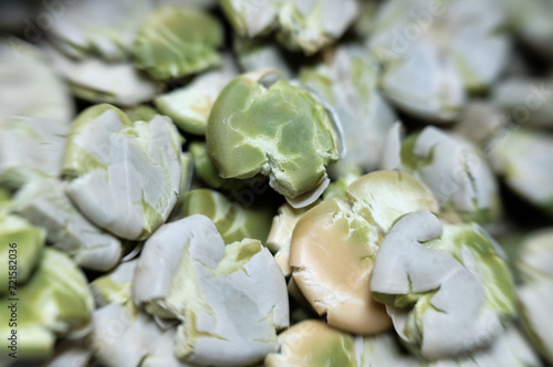 Flattened edible peas in grains close-up macro shooting