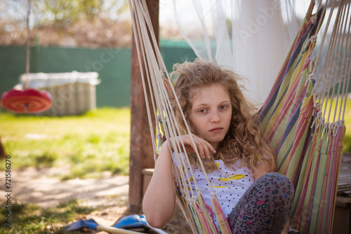 bored teenage girl in hammock swing