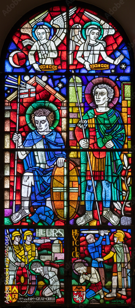 BERN, SWITZERLAND - JUNY 27, 2022: The St, Ursus of Solothurn and St. Victor on the stained glass in the church Dreifaltigkeitskirche by A. Schweri (1938).