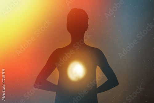 Human silhouette radiating light from within with energies and stars.