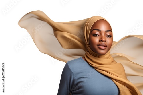 Portrait of beautiful black skin woman wearing hijab over white png background. Waving head scarf, femininity, concept of goods for muslim islamic women. Copy space for text and design. photo