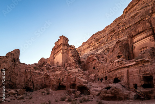 Tombs line along a hill on the Street of Facades in the ancient Jordanian city of Petra called the Valley of the Kings. Hot sunny day