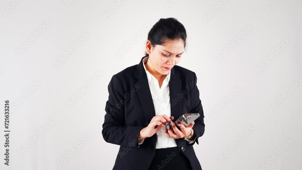Focused smiling business woman using smart phone against a white background Focused smiling business woman using smart phone against a white background