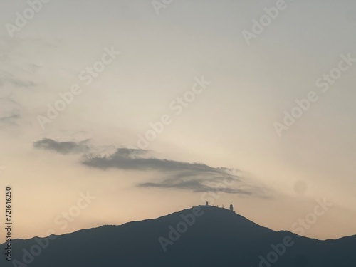 Silhouetted figures atop a mountain at twilight: Tai Mo Shan, Hong Kong