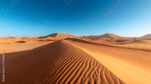 sand dunes in the desert, surreal desert landscape with towering sand dunes, stretching as far as the eye can see, under a clear blue sky