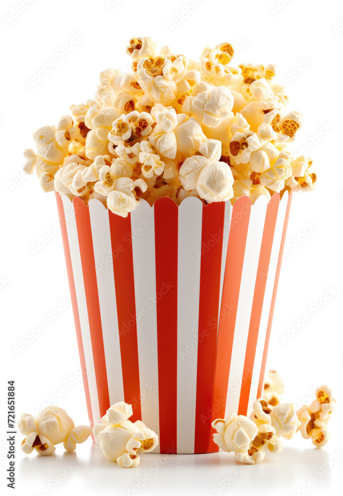 A close-up image capturing an overflowing striped container of freshly popped, golden popcorn against a light background A close-up image capturing an overflowing striped container of freshly popped, golden popcorn against a light background