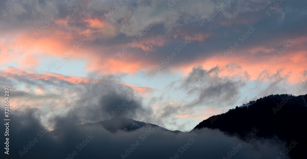 Sunset after a rainy day with grey and red clouds over the Val d'Ultimo near Merano in South Tyrol Sunset after a rainy day with grey and red clouds over the Val d'Ultimo near Merano in South Tyrol