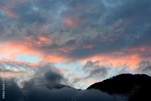 Sunset after a rainy day with grey and red clouds over the Val d'Ultimo near Merano in South Tyrol 