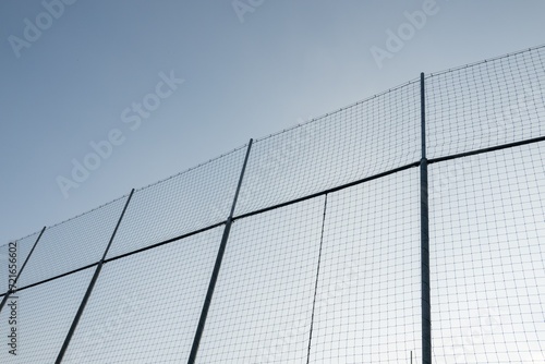 Wire fence around sport stadium to prevent ball to fly away