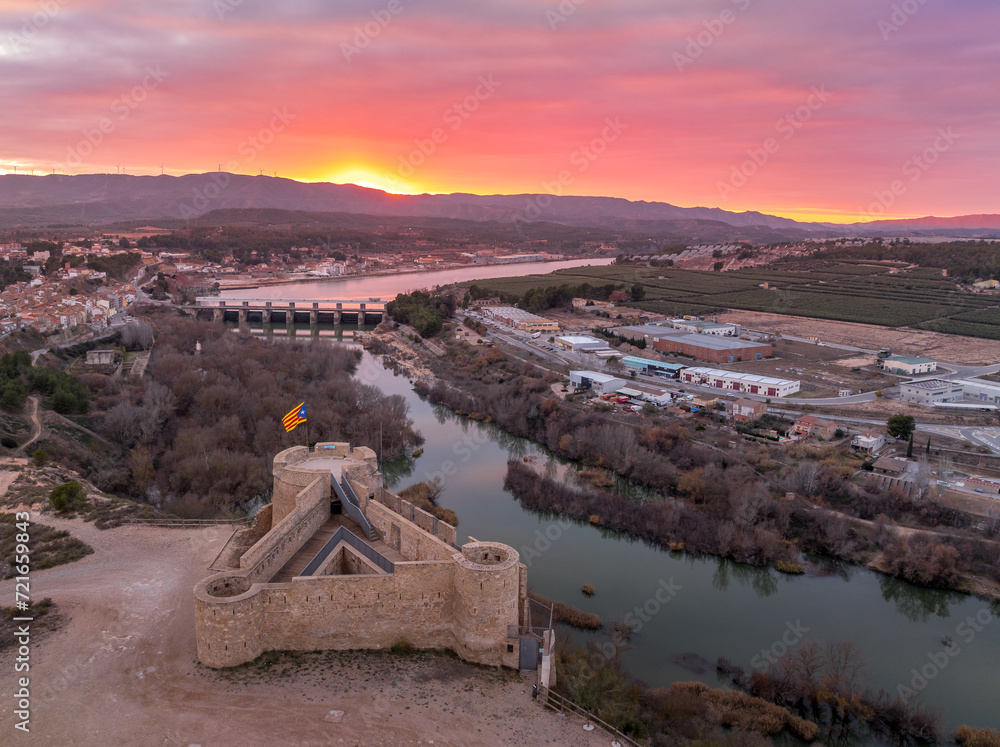 Aerial colorful sky sunset panoramic view of Flix new castle above the Ebro river in Spain with triangular shape circular gun platforms