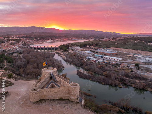 Obraz na płótnie Aerial colorful sky sunset panoramic view of Flix new castle above the Ebro river in Spain with triangular shape circular gun platforms w salonie