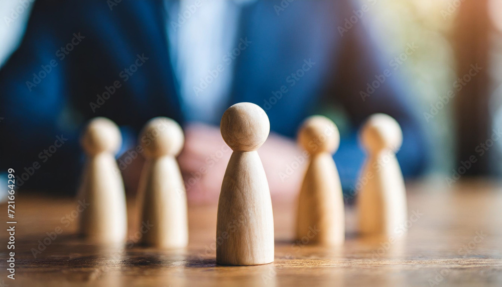 Wooden figure stands tall among diverse group, symbolizing leadership, unity, and influence in a collaborative environment Wooden figure stands tall among diverse group, symbolizing leadership, unity, and influence in a collaborative environment