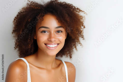 Close up studio portrait of beautiful young black woman against white background.