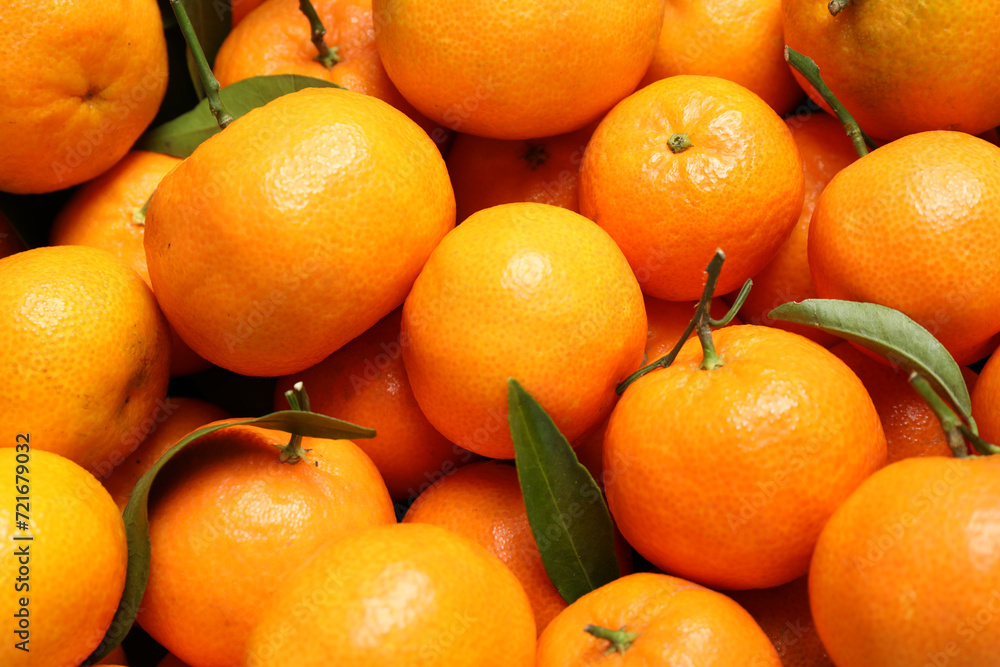 Fresh ripe tangerines with leaves as background, top view. Citrus fruit Fresh ripe tangerines with leaves as background, top view. Citrus fruit