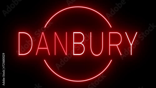 Flickering red retro style neon sign glowing against a black background for DANBURY photo