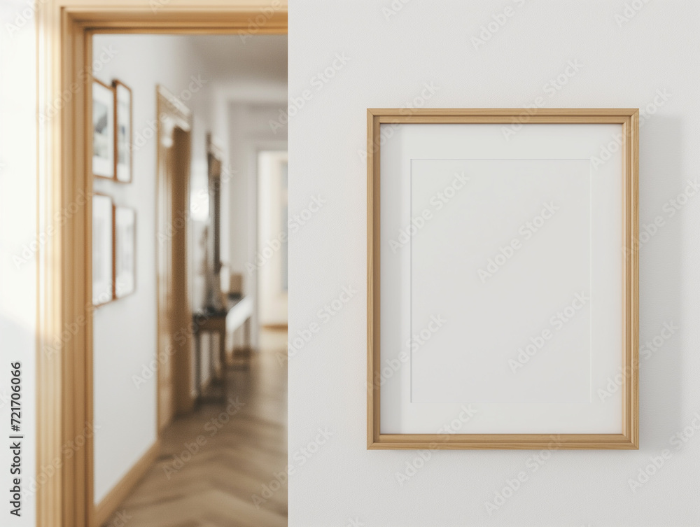 Fototapeta premium empty rectangle birch wood frame mockup hanging on a white wall in a hallway.