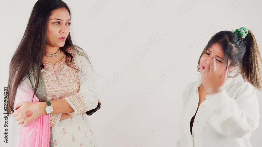 Two women smiling and interacting with each other in a party gossips talking on white background Two women smiling and interacting with each other in a party gossips talking on white background