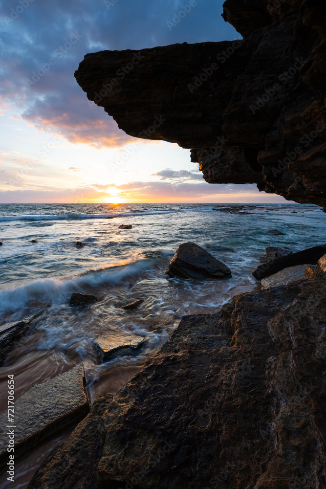 Beautiful sunrise view from rocky cliff on the beach shore. Beautiful sunrise view from rocky cliff on the beach shore.