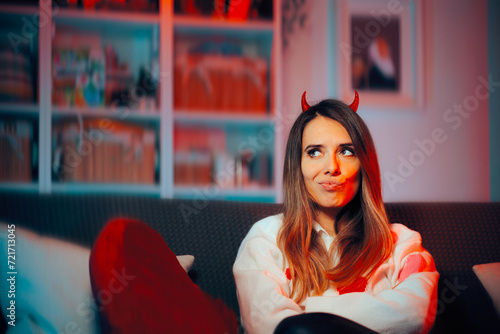 Obraz na plátně Funny Mean Girl Wearing Devil Horns Making Malicious Plans