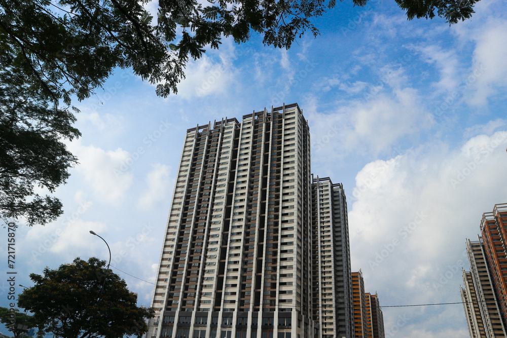Front up view of modern residential apartement building with blue sky in background