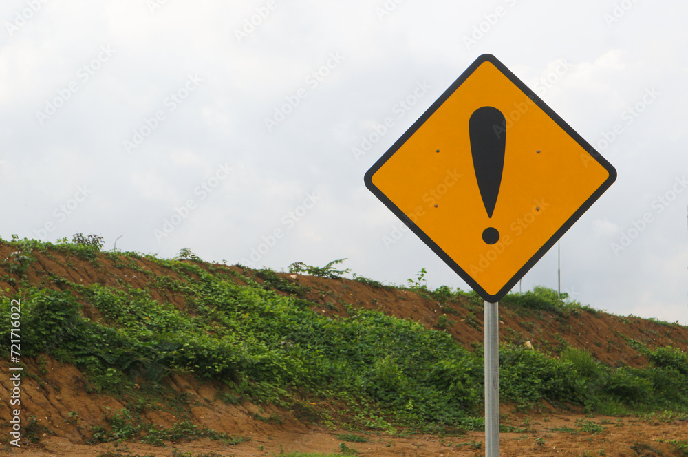 Exclamation mark on a yellow road sign. Warning, danger, attention.