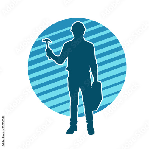 Silhouette of a worker carrying hammer tool. Silhouette of a worker in action pose using hammer tool.