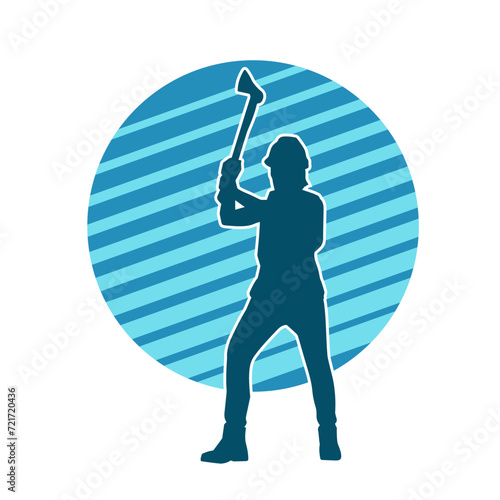 Silhouette of a worker in action pose using his axe tool.