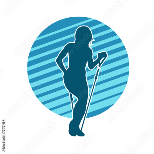 Silhouette of a sporty woman at gym workout using pull rope. Fitness exercise cords pull rope stretch resistance training.  © anom_t