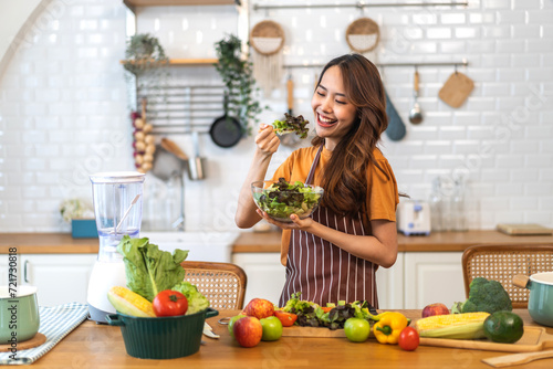 Portrait of beauty body slim healthy asian woman eating vegan food healthy with fresh vegetable salad in kitchen at home.diet  vegetarian  fruit  wellness  health  green food.Fitness and healthy food