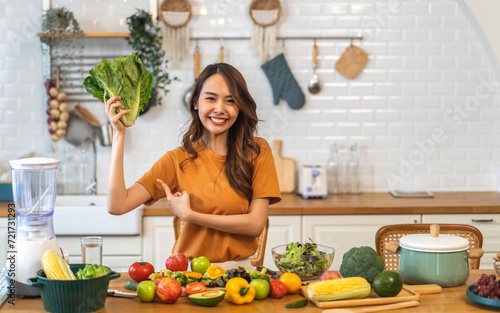 Portrait of beauty body slim healthy asian woman eating vegan food healthy with fresh vegetable salad in kitchen at home.diet, vegetarian, fruit, wellness, health, green food.Fitness and healthy food