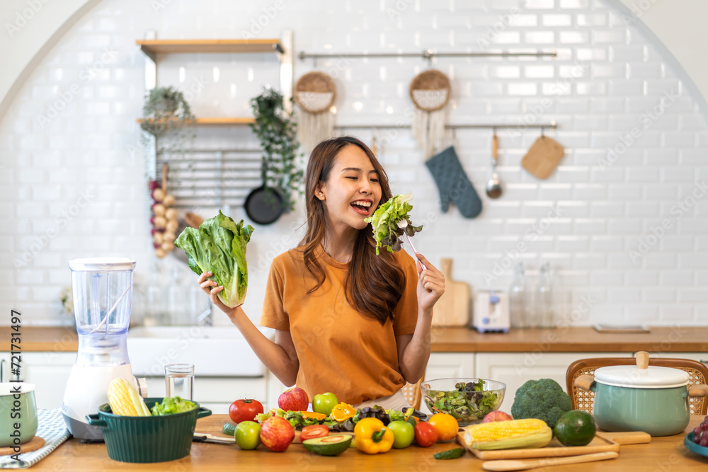 Portrait of beauty body slim healthy asian woman eating vegan food healthy with fresh vegetable salad in kitchen at home.diet, vegetarian, fruit, wellness, health, green food.Fitness and healthy food Portrait of beauty body slim healthy asian woman eating vegan food healthy with fresh vegetable salad in kitchen at home.diet, vegetarian, fruit, wellness, health, green food.Fitness and healthy food