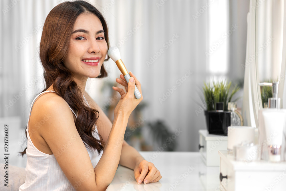 Smiling beautiful asian woman fresh healthy white skin, clean, looking at mirror.asian girl touching on face applying cream, skincare, cosmetics, cosmetology, beauty, fashion at home.spa and wellness Smiling beautiful asian woman fresh healthy white skin, clean, looking at mirror.asian girl touching on face applying cream, skincare, cosmetics, cosmetology, beauty, fashion at home.spa and wellness