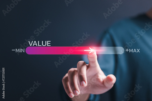 Person touch virtual screen of progress bar with the word VALUE for growth value, increase value, value added and business growth concept.