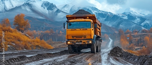 A dump truck removes heated asphalt. Building a new roadway photo