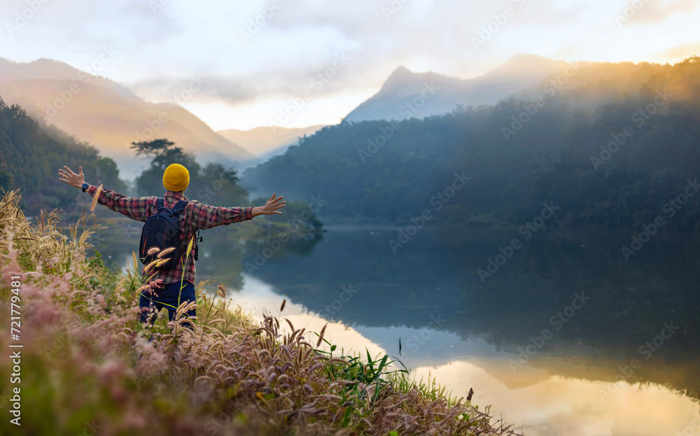 Asian naturalist hiking at destination while exploring wildlife in the
