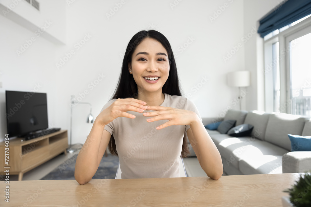 Cheerful beautiful Asian gen Z student girl talking on online conference chat at workplace table, smiling, laughing, speaking, looking at camera. Video call screen, head shot portrait Cheerful beautiful Asian gen Z student girl talking on online conference chat at workplace table, smiling, laughing, speaking, looking at camera. Video call screen, head shot portrait