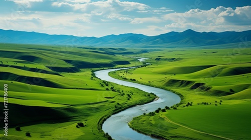 Aerial view of bright green fields with river canal in countryside