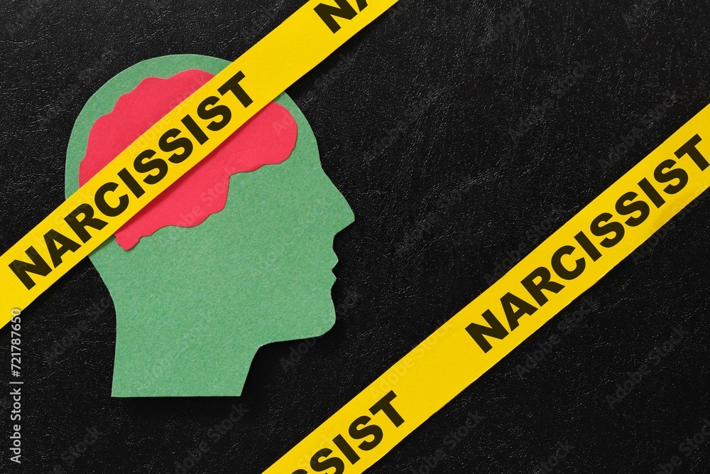 Human head profile with word narcissist in dark black background. Narcissistic behavior concept.