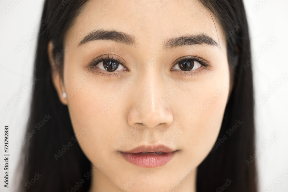 Beautiful female Asian beauty care models face front close up. Calm relaxed young Korean woman with soft clean perfect skin looking at camera, posing for cropped portrait Beautiful female Asian beauty care models face front close up. Calm relaxed young Korean woman with soft clean perfect skin looking at camera, posing for cropped portrait