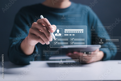 Businessman use tablet to checking resume for employee recruitment. Screening employee information and job applicants. HR, Human resource management concept.
