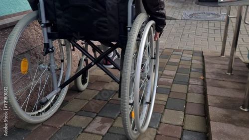 Teenage child in wheelchair using ramp concept photo