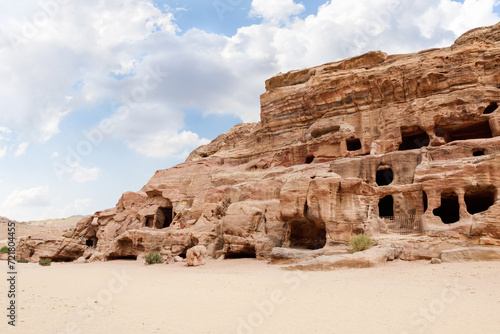 Rocks dotted with the many caves carved by Nabatean craftsmen in Nabatean Kingdom of Petra in the Wadi Musa city in Jordan