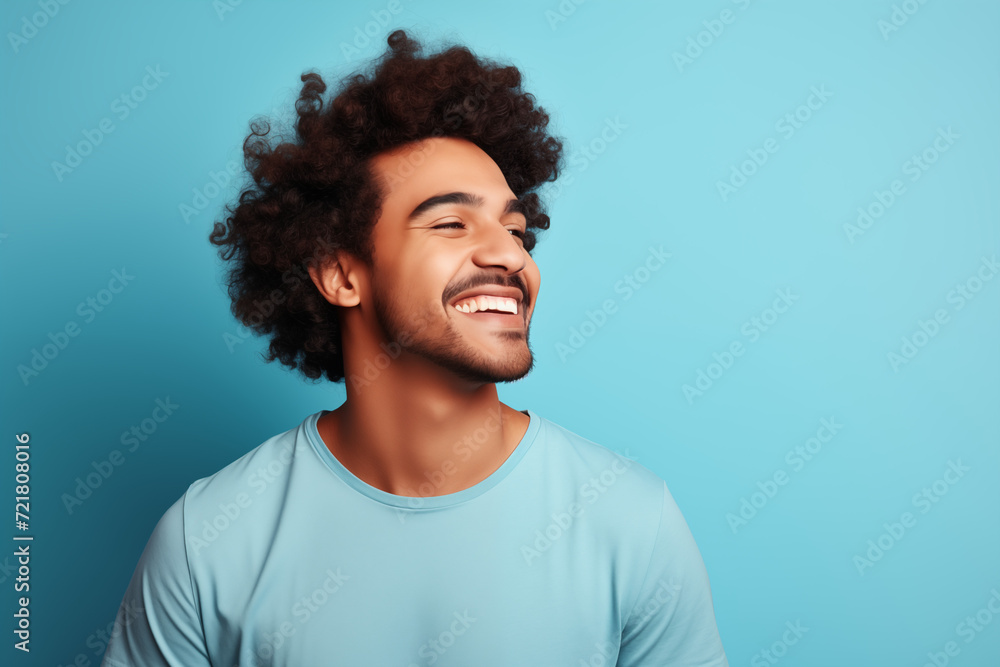 Obraz premium The young boy laughed with a natural smile on his face. blue background. Y002