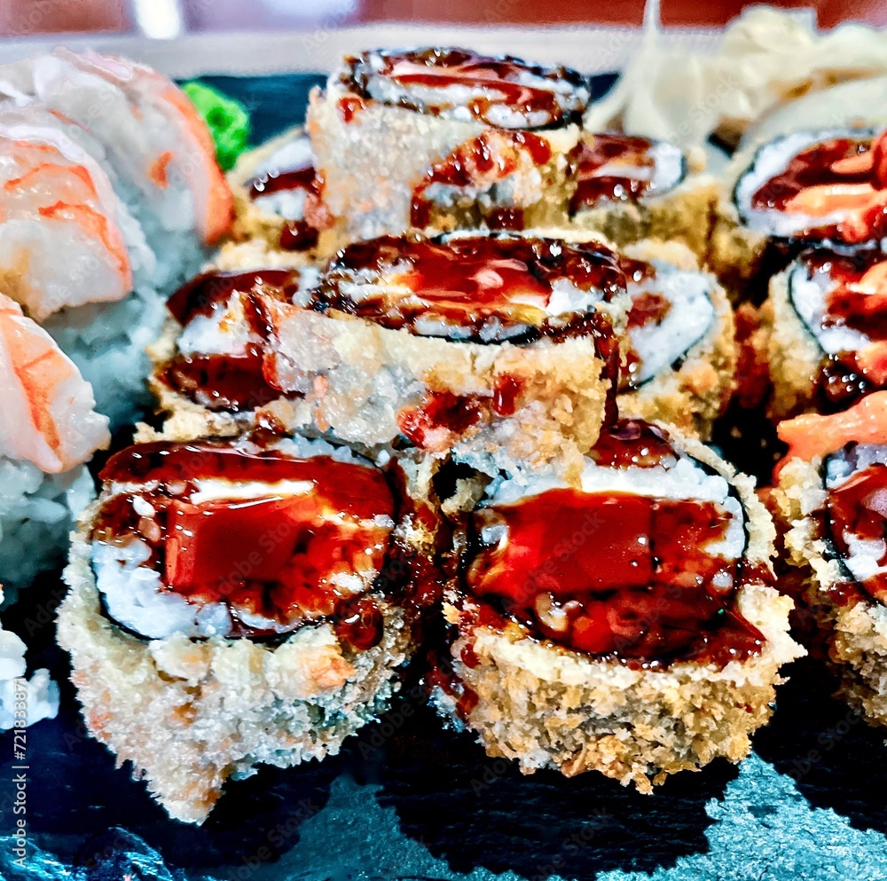 Sushi set on a black plate, close-up, top view