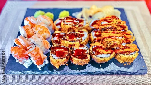 Obraz na płótnie Sushi set on a black plate, close-up, top view w salonie
